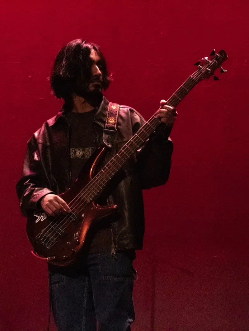 Sahil playing bass on stage